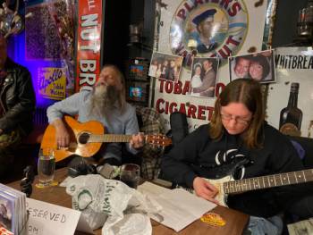 Photo of Alan.s.Robinson on acoustic guitar and katherine robinson on electric guitar at Roots kimberley